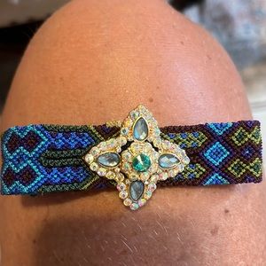 Multi colored woven bracelet with gem stone design.